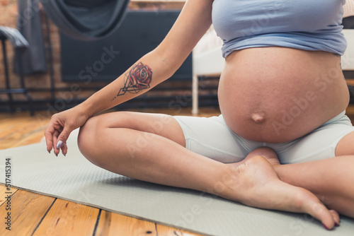 pregnant woman doing relaxing exercises, motherhood concept. High quality photo