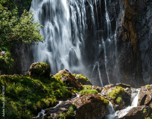 Falling water in a waterfall creates a cloud of water dust.