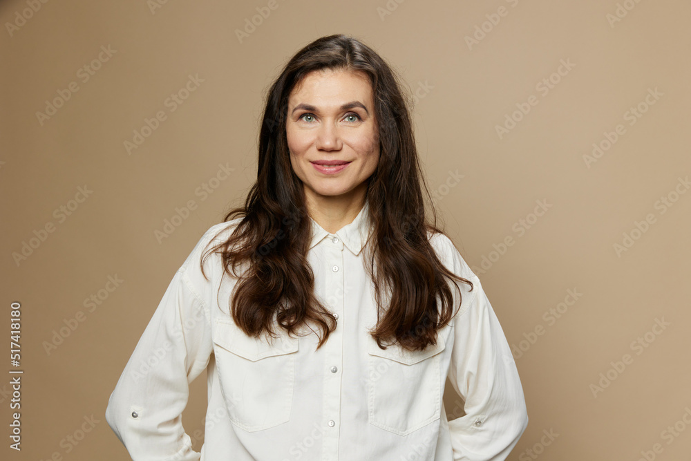 a beautiful horizontal portrait of an adult woman with black hair flowing in the wind standing in a white shirt. Studio photo with an empty space on the background a beautiful horizontal portrait of an adult woman with black hair flowing in the wind standing in a white shirt. Studio photo with an empty space on the background