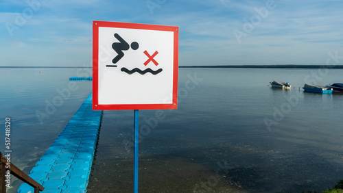 No Diving sign at beach, lake Naroch, Belarus. Warning sign of shallow water. Warning notice sign do not jump in water.