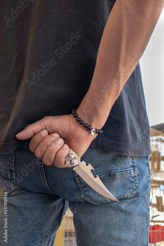 man holding pocket knife in hand