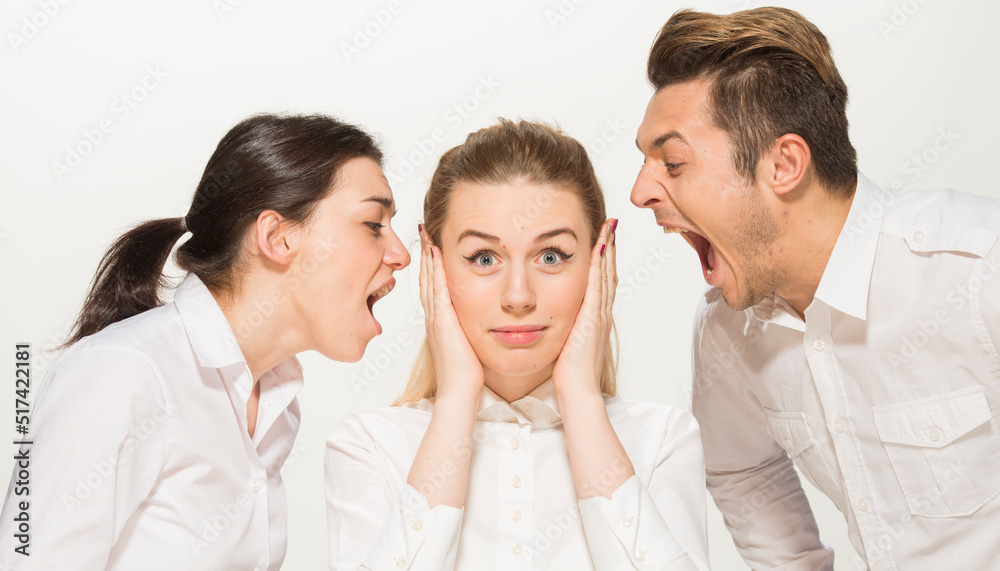 team of young business people in white shirts on a white background isolated. a team of two girls and a guy is happy, wins, plans, argues, discusses, gets upset, wins something. close-up portrait team of young business people in white shirts on a white background isolated. a team of two girls and a guy is happy, wins, plans, argues, discusses, gets upset, wins something. close-up portrait