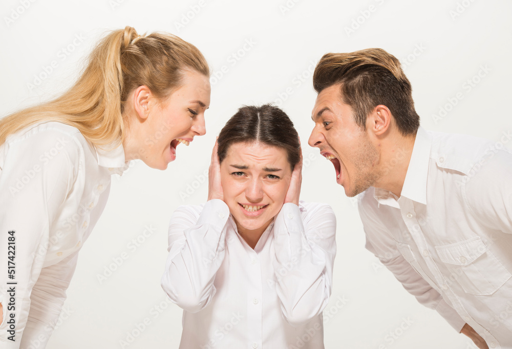 team of young business people in white shirts on a white background isolated. a team of two girls and a guy is happy, wins, plans, argues, discusses, gets upset, wins something. close-up portrait team of young business people in white shirts on a white background isolated. a team of two girls and a guy is happy, wins, plans, argues, discusses, gets upset, wins something. close-up portrait