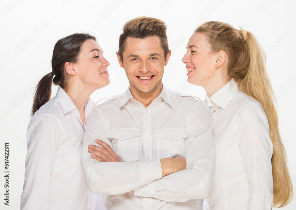 team of young business people in white shirts on a white background isolated. a team of two girls and a guy is happy, wins, plans, argues, discusses, gets upset, wins something. close-up portrait team of young business people in white shirts on a white background isolated. a team of two girls and a guy is happy, wins, plans, argues, discusses, gets upset, wins something. close-up portrait