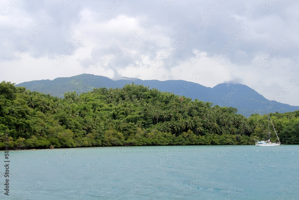 Clouds, mountains, trees, water and boat