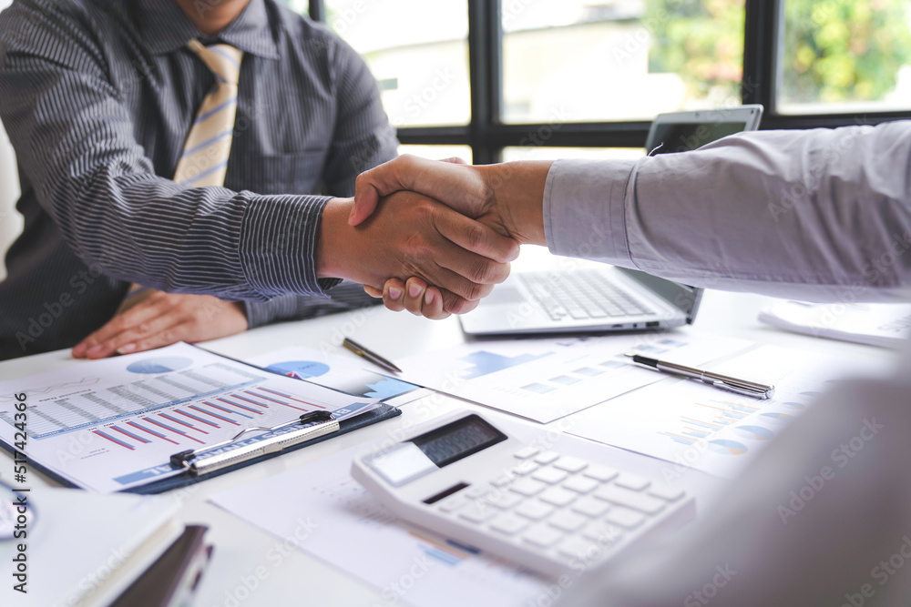 Two confident executive business shaking hands during a meeting to deal with complete agreement contract and become a business join venture success creativity ideas concept
