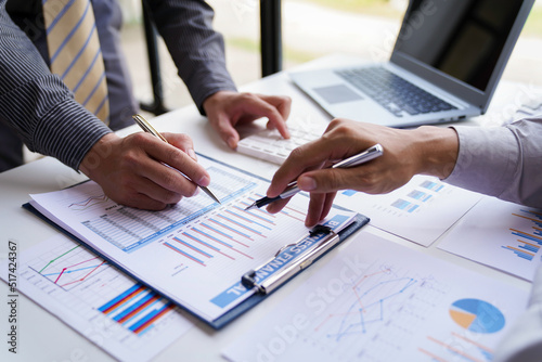 Teamwork, analyze, Business meeting.business team brainstorming discussing with paper graph chart in the office while sitting at the office table together