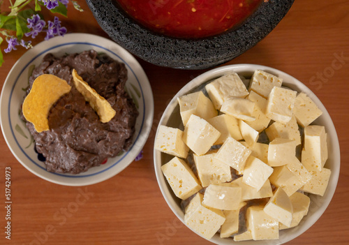 Some mexican Cheese with refried beans and red sauce 