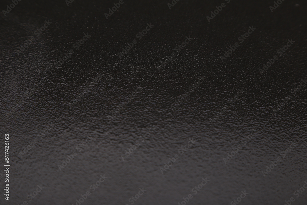 Dark gray background from natural slate. Texture of stone closeup. Graphite background macro