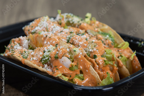 Quadro em tela Triplet order of shrimp tacos covered in parmesan cheese and secret sauce for a