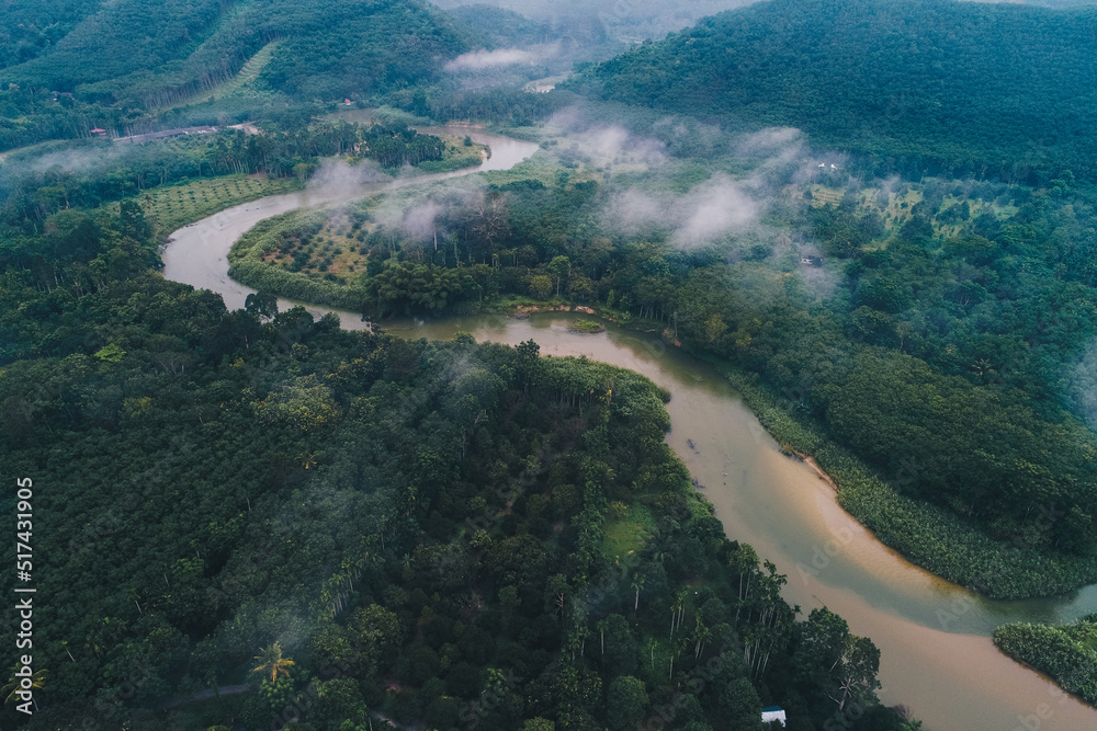 Aerial view canal river in tropical rainforest with morning fog