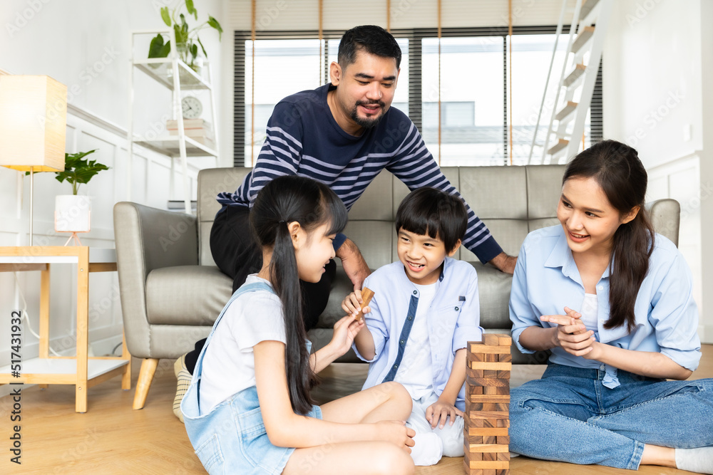 Happy asian family dad and child son building constructor from blocks.Loving parents having fun with kids in the living room at home. Happy asian family dad and child son building constructor from blocks.Loving parents having fun with kids in the living room at home.