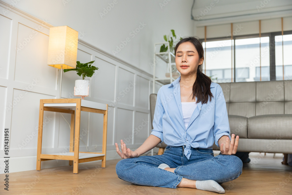 Young asian woman doing yoga exercise indoors at home, meditating. Young asian woman doing yoga exercise indoors at home, meditating.