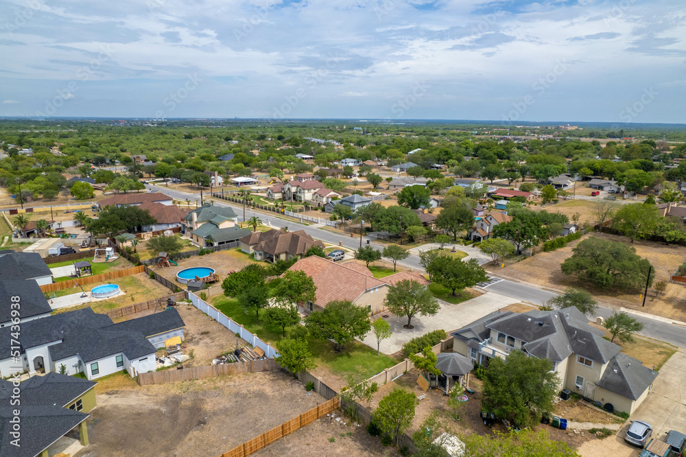 Aerial drone view of American suburban neighborhood. Establishing shot of America's suburb. Residential single family houses pattern.