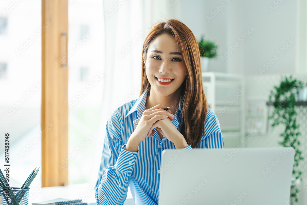 Smiling beautiful business asian woman working in office use computer with copy space. Business owner people sme freelance online marketing e-commerce telemarketing Smiling beautiful business asian woman working in office use computer with copy space. Business owner people sme freelance online marketing e-commerce telemarketing