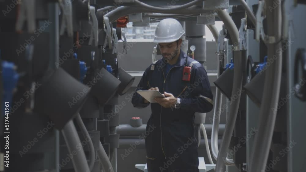 Engineer under checking the industry chilled water fan coil unit air conditioner is water cooling tower air chiller HVAC system of large industrial building to control air system 