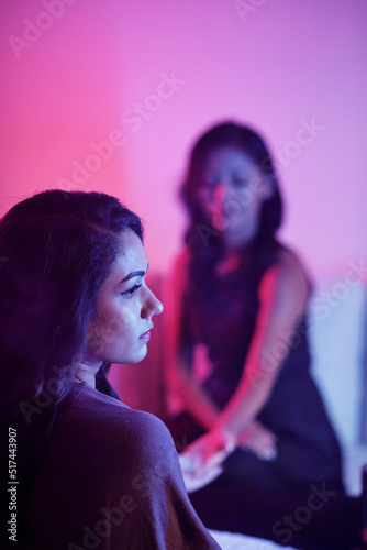 Sad pensive young woman came to fortune teller to find answer to her problem photo