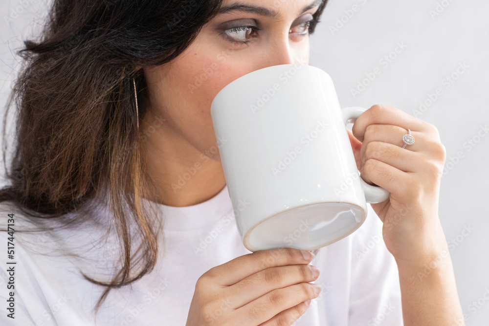 Mockup of a white blank mug featuring a woman drink from it Mockup of a white blank mug featuring a woman drink from it