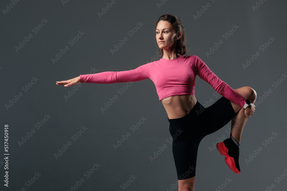 Portrait of young woman in sportswear, doing fitness exercise