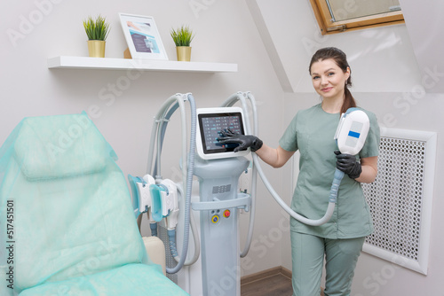 Woman doctor in medicine salon holds vacuum massage apparatus. Anti-cellulite body shaping procedure. Apparatus for weight loss. Woman and doctor in medicine salon.