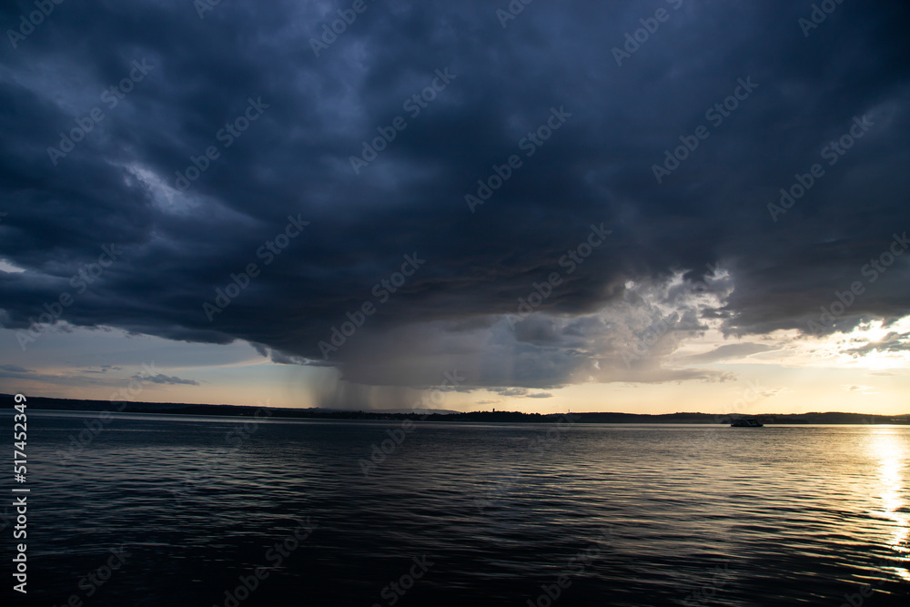 Heavy dark fast moving thunderstorm clouds over lake Constance, Germany