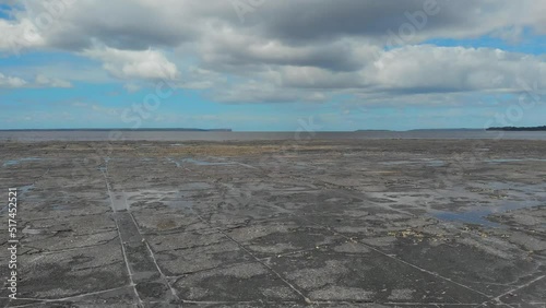 Drone video of Moona Moona Creek and Huskisson beach area after recent flooding with brown dirty water flowing into the bay photo