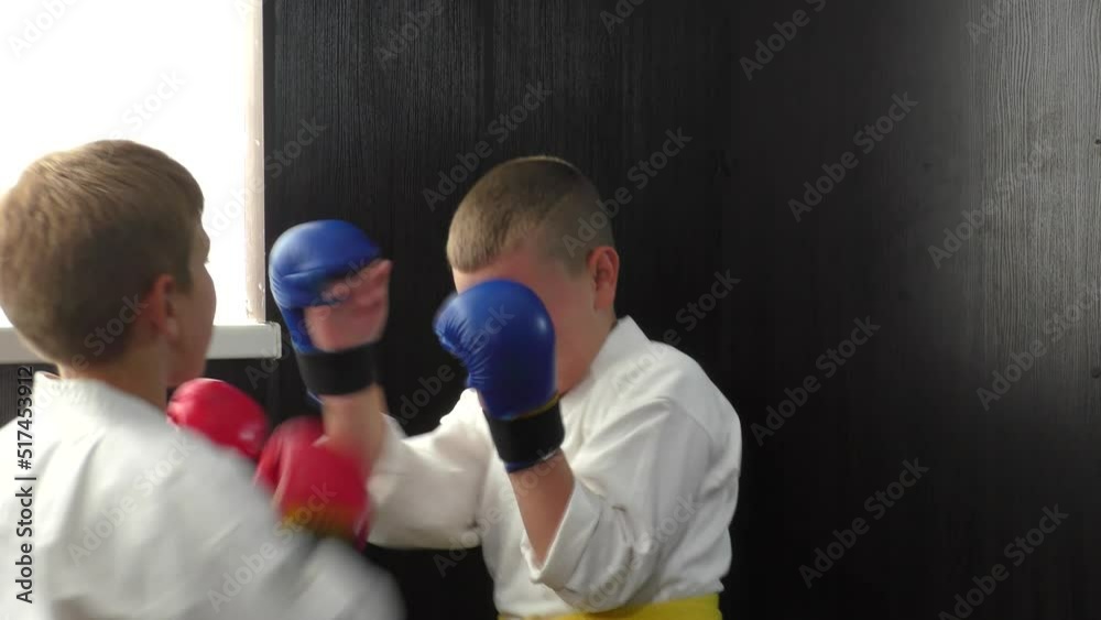Two athletes with red and blue pads on their hands do active paired exercises Two athletes with red and blue pads on their hands do active paired exercises