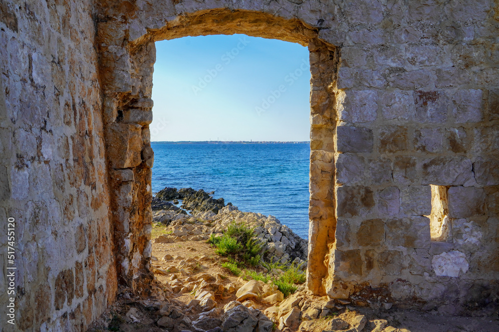 A stone door with a view of the Adriatic Sea
