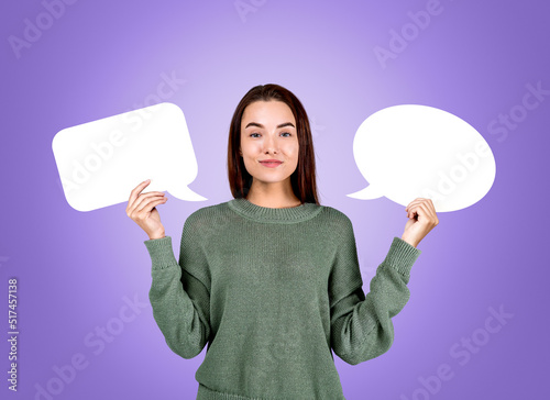 Young woman holding two mockup speech bubbles, idea and plan