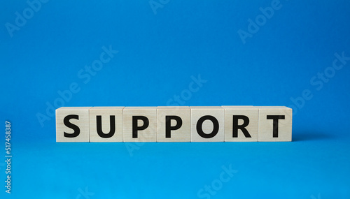 Support symbol. Concept word Support on wooden cubes. Beautiful blue background. Business and Support concept. Copy space.