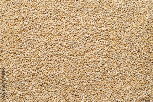 Uncooked white quinoa grains, top view, texture. Quinoa grain or seeds for texture or ingredient background.