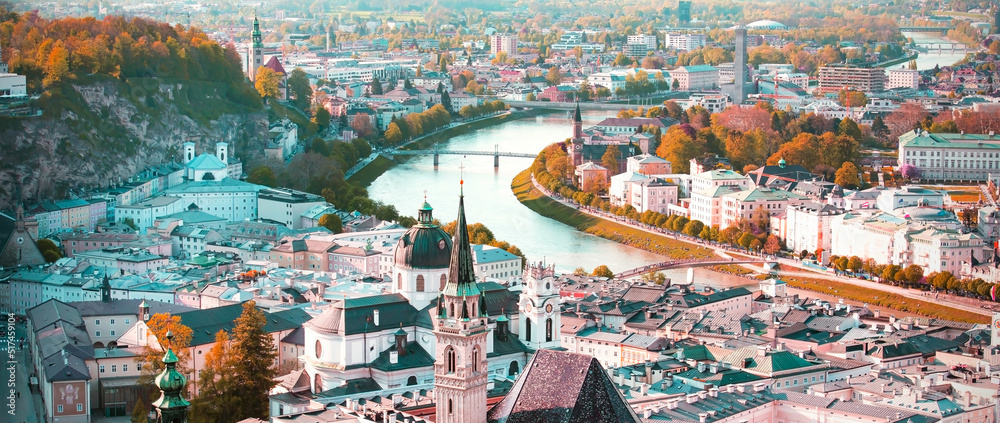 Obraz na płótnie Banner travel with  panoramic view in a Autumn season at a historic city of Salzburg with Salzach river in beautiful golden evening light sky and colorful of autumn at sunset, Salzburger Land, Austria w salonie