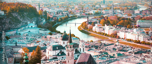 Banner travel with  panoramic view in a Autumn season at a historic city of Salzburg with Salzach river in beautiful golden evening light sky and colorful of autumn at sunset, Salzburger Land, Austria