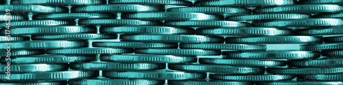 Money wall. Chaotic pile of coins close-up. Nickel coin textured banner. Teal tinted business header made of many coin edges. Economy finance and bank headline. Tax and credit. Macro