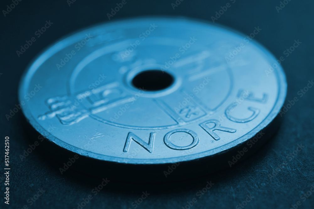 Translation: Norway. 1 Norwegian krone coin close up. National currency of Norway. Blue tinted money background for news about economy or finance. Loan and credit. Tax and inflation. Macro