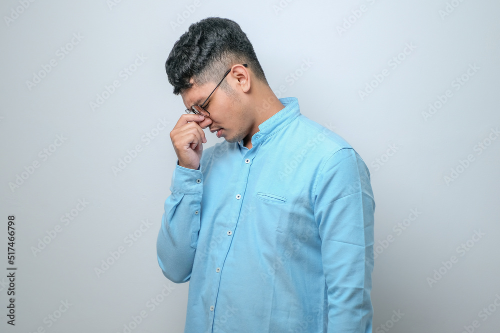 Young handsome asian man with hand on head for pain in head because stress. Suffering migraine. Young handsome asian man with hand on head for pain in head because stress. Suffering migraine.