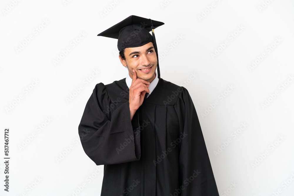 Young university graduate over isolated white background thinking an idea while looking up Young university graduate over isolated white background thinking an idea while looking up