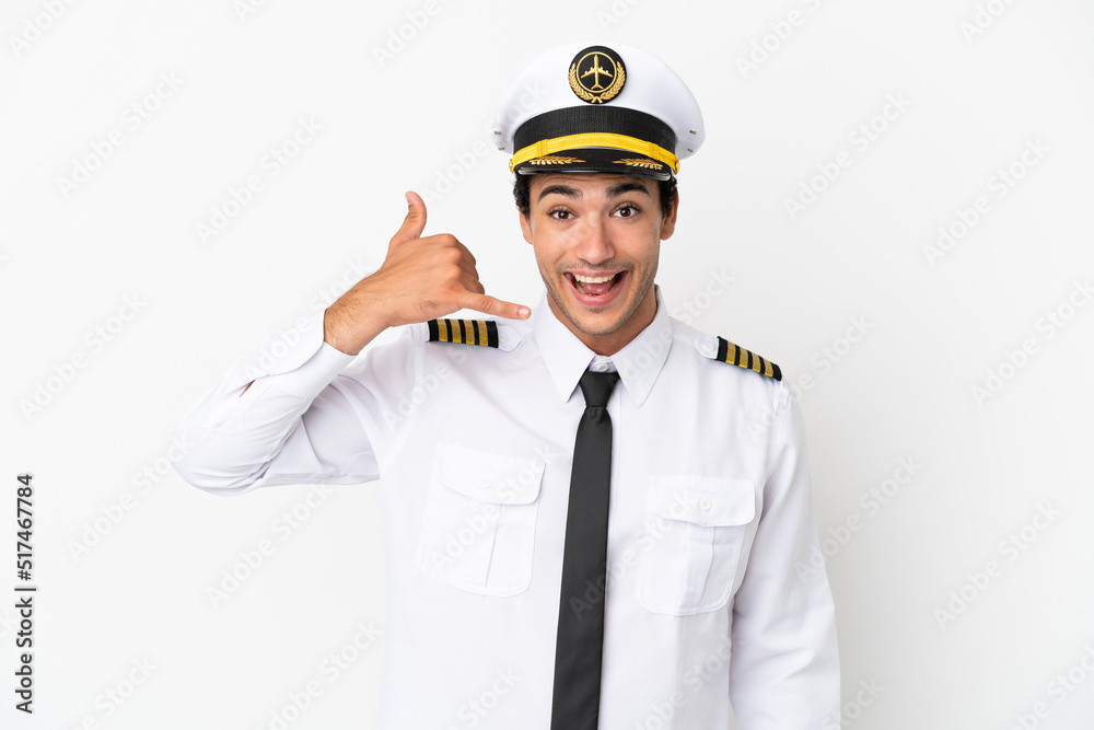 Airplane pilot over isolated white background making phone gesture. Call me back sign Airplane pilot over isolated white background making phone gesture. Call me back sign