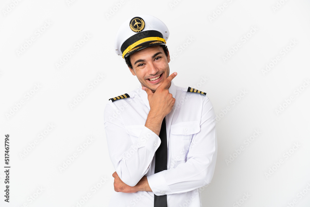 Airplane pilot over isolated white background smiling Airplane pilot over isolated white background smiling