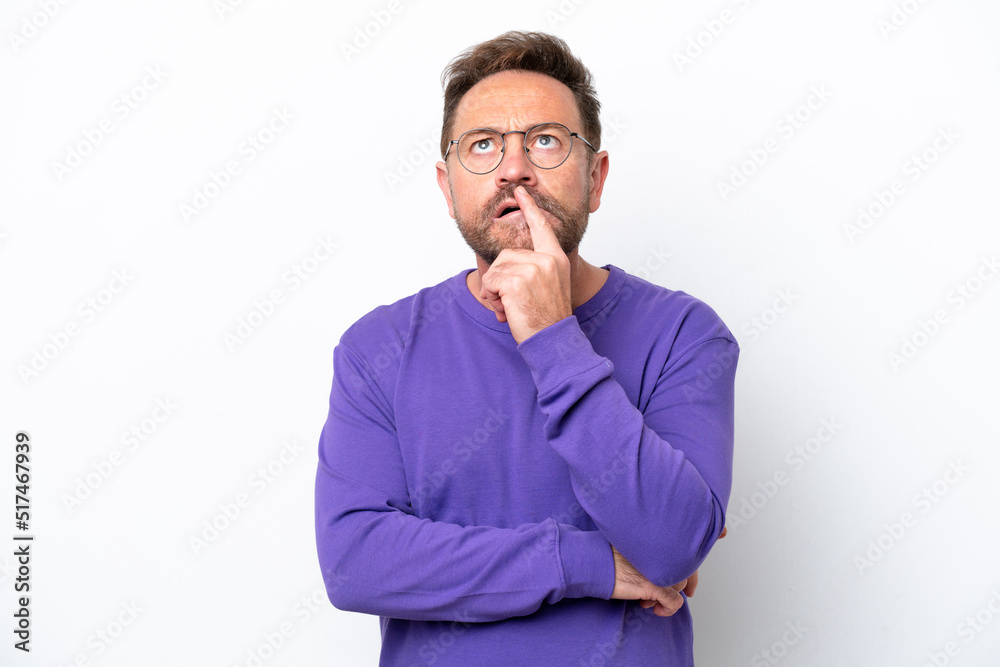 Middle age caucasian man isolated on white background having doubts while looking up Middle age caucasian man isolated on white background having doubts while looking up