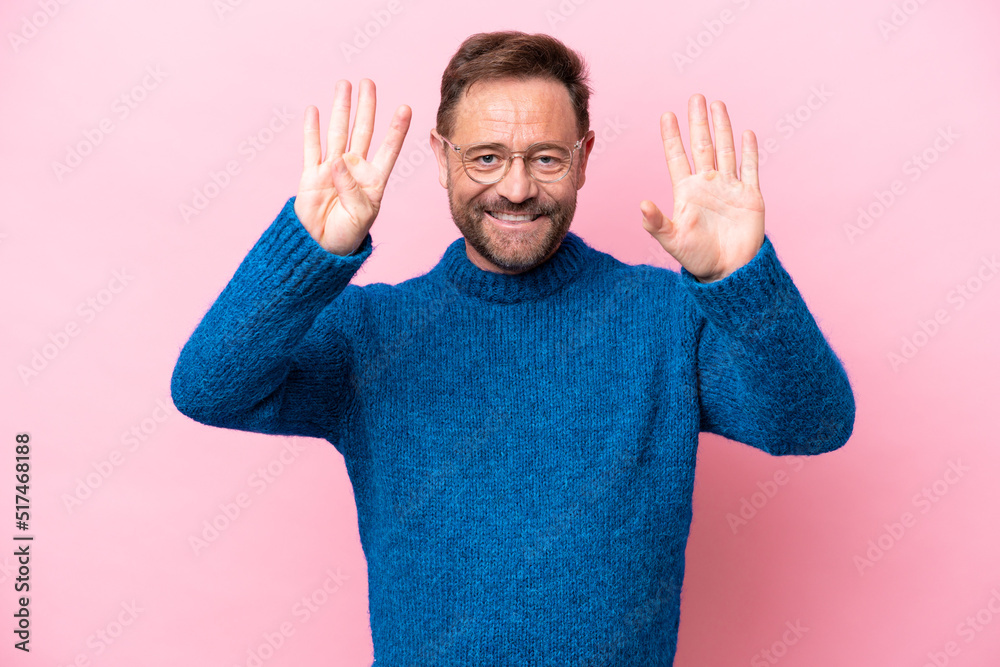 Fototapeta premium Middle age caucasian man isolated on pink background counting nine with fingers