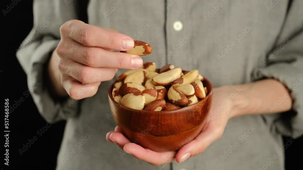 Female hold brazilian nuts in hand. Female hold brazilian nuts in hand.