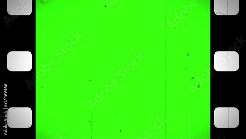 Old camera roll animation on green color.  Black film reel scrolling vertically with noise, flicker, scratches, dust, hair, light leaks effects. Loopable, vintage film frame. 4k, Retro template. photo