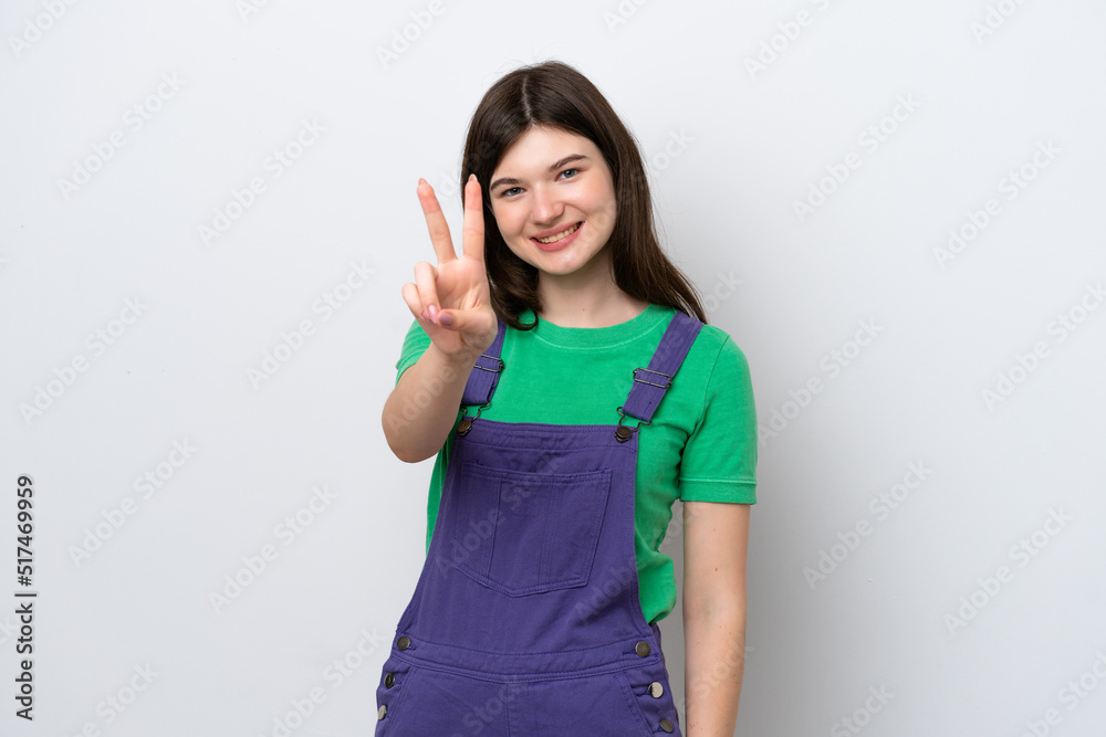 Young Russian woman isolated on blue background smiling and showing victory sign Young Russian woman isolated on blue background smiling and showing victory sign