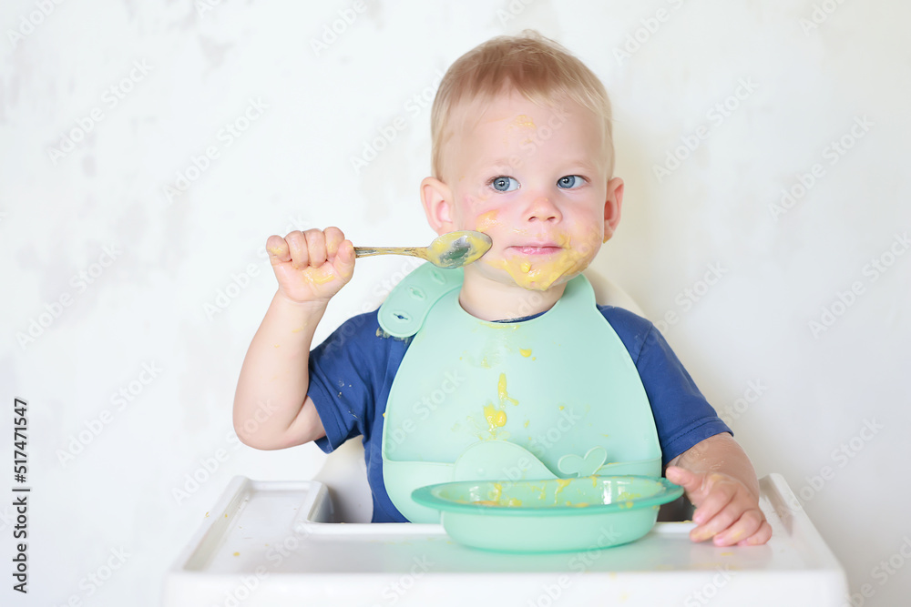 kid eats with a spoon and learns by himself kid eats with a spoon and learns by himself
