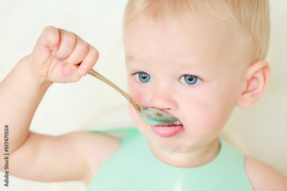 kid eats with a spoon and learns by himself kid eats with a spoon and learns by himself