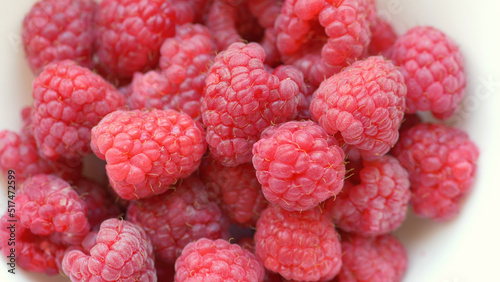 Fresh, raw raspberries in a white bowl.  Fruits.