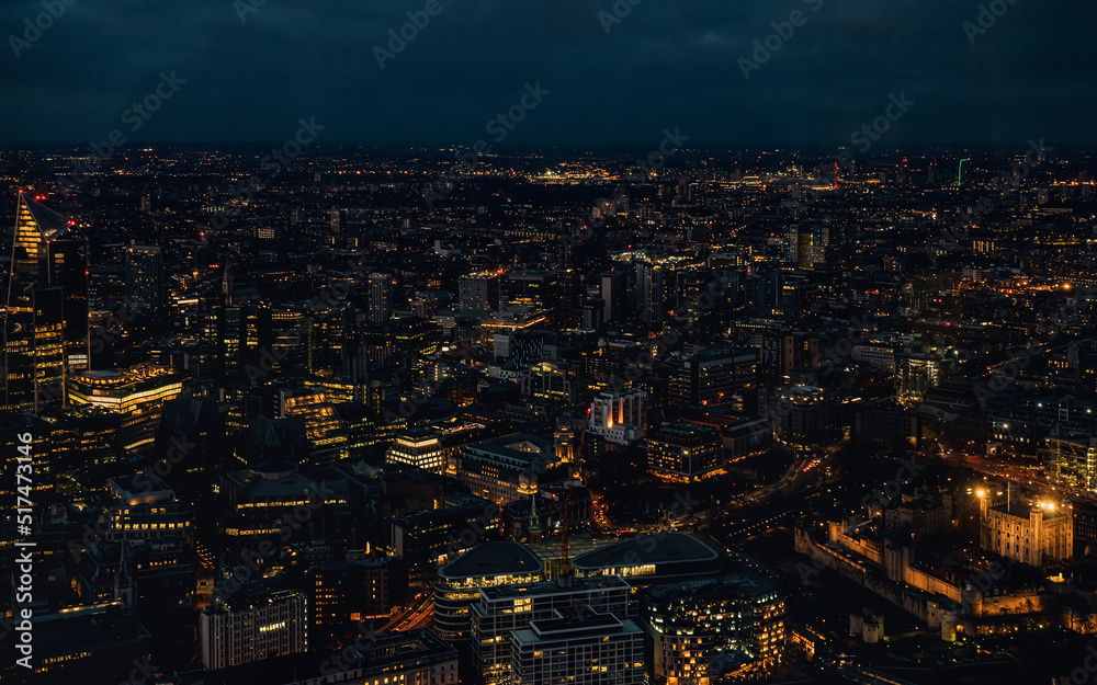 Aerial view of north east London, just after dark, orange yellow street lights starting to glow