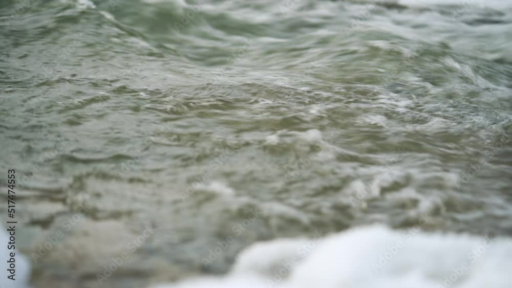 Winter river surface with snow crystals and ice floating on water - closeup detail, camera slides slowly to side Winter river surface with snow crystals and ice floating on water - closeup detail, camera slides slowly to side