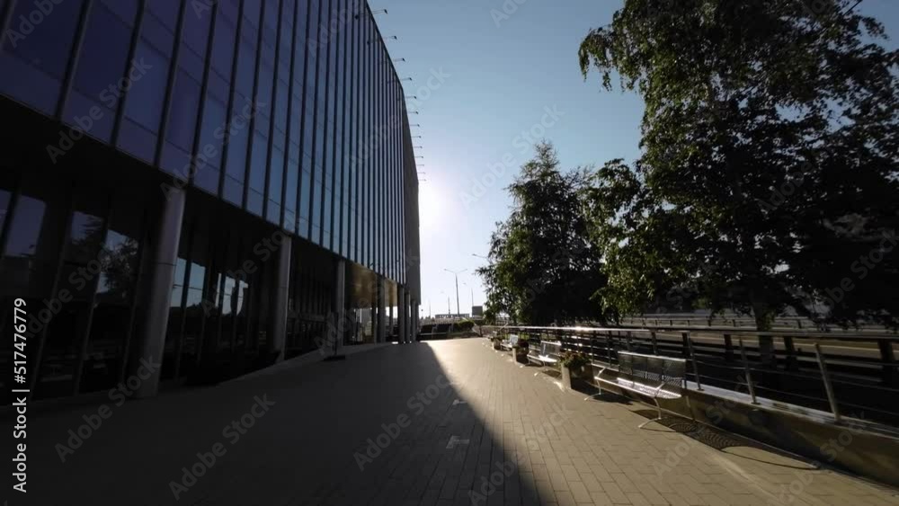 Modern urban building with glass windows. City business district. 4k slow motion video footage with wide angle lens Modern urban building with glass windows. City business district. 4k slow motion video footage with wide angle lens
